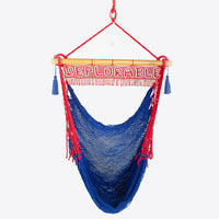 Outdoor and indoor hanging chair hammock. Blue hammock chair with Deplorable sign.