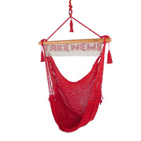 Handmade outdoor and indoor red hammock chair with Fake News sign